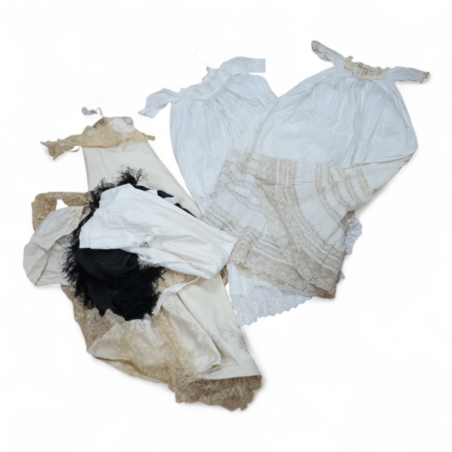An embroidered cream wool christening cape, christening robes, bonnets and a small black silk shawl, christening gown 84cm long. Condition - lace border of the cape is detached. The gowns caps etc need laudering. Good fo